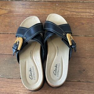 Clarks Black Cross-Strap Sandals with Gold Accent